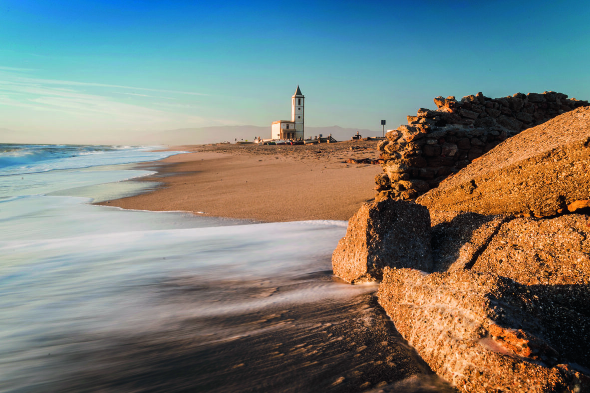 San Miguel church viewed from the beach at Las Salinas, Cabo de Gata-Nijar Natural Park, Almeria Province, Andalucia, Spain
